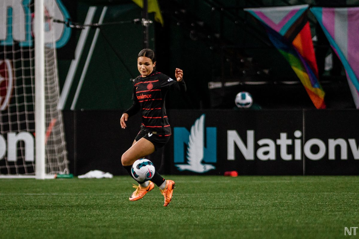 Portland Thorns player Sophia Smith dances with the ball at her feet during an NWSL game.