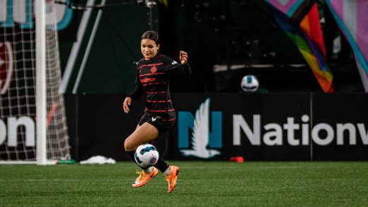 Portland Thorns player Sophia Smith dances with the ball at her feet during an NWSL game.
