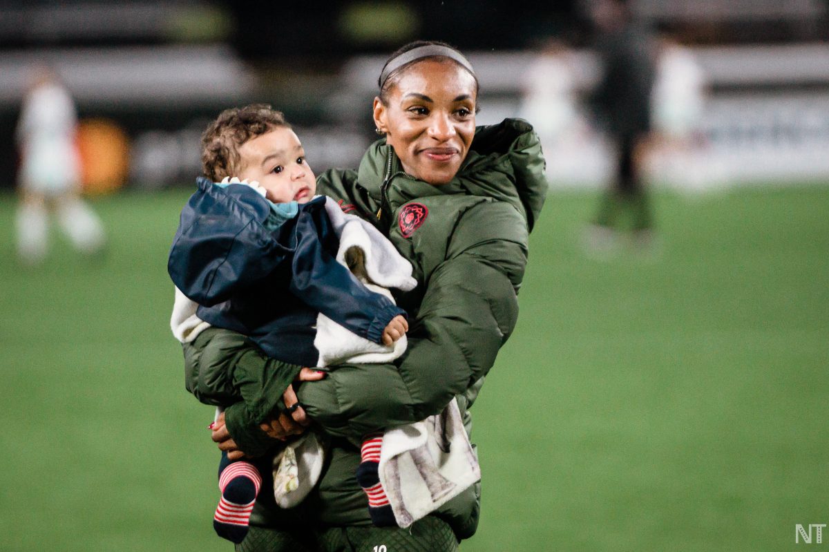 Crystal Dunn holding son Marcel. (Photo by Nikita Taparia)